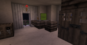 Bureau dans Minecraft avec un (faux) ordinateur où sur l'écran il est écrit "Mindows 10"