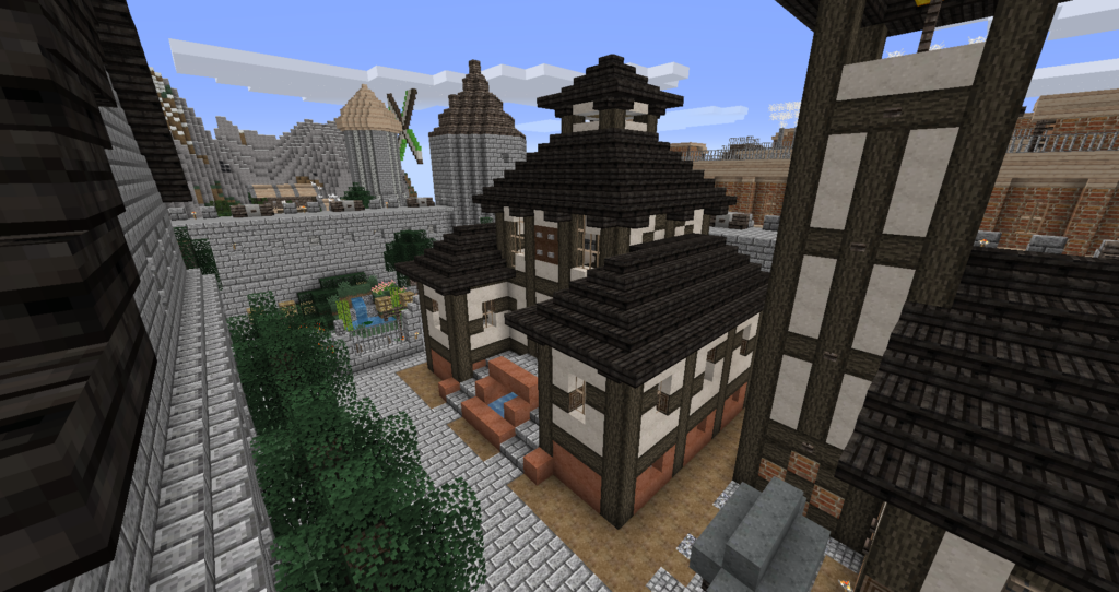 Minecraft - bâtiment médiéval (d'inspiration japonaise et européenne) à 45° dans une ville médiévale